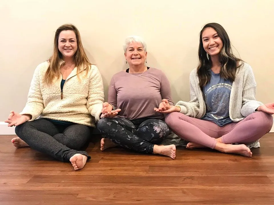 3 happy women in a yoga class at the Island Community House.